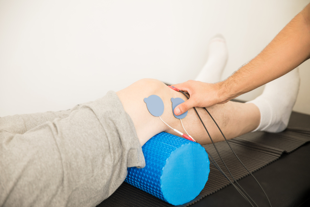 closeup-physiotherapist-s-hand-positioning-electrodes-patient-s-knee-hospital.jpg